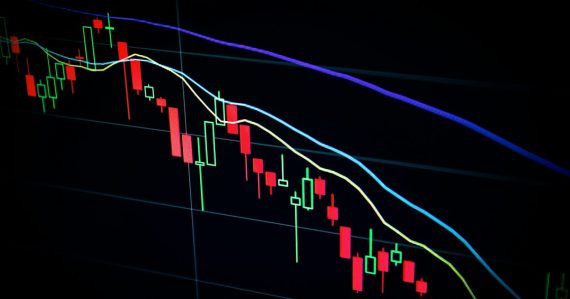 Stock market candlestick chart on dark screen, illustrating cloud computing for high-end trading