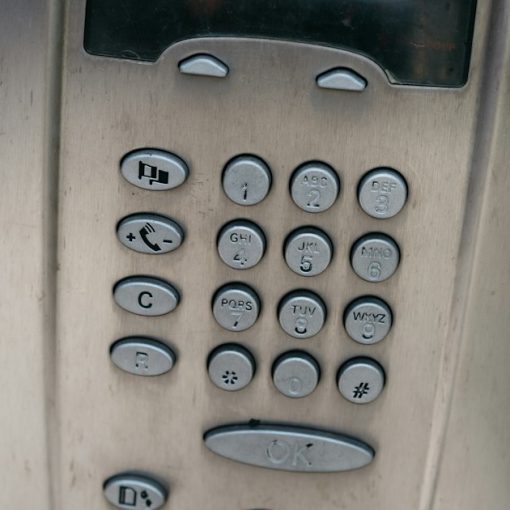 A close up of a phone with a red cord, illustrating reasons to choose hosted VoIP