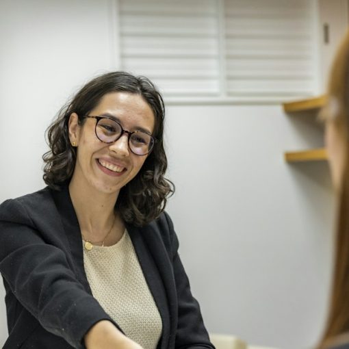 HR manager shaking hands with a candidate across a table, illustrating HR managing cloud computing risk