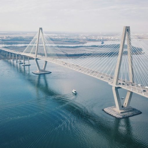 Aerial view of a long bridge over water, illustrating hybrid cloud computing connecting on-premise and cloud