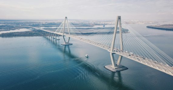 Aerial view of a long bridge over water, illustrating hybrid cloud computing connecting on-premise and cloud