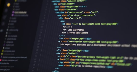 Computer screen displaying HTML code for a web development project, illustrating Hyper-V in Windows 8