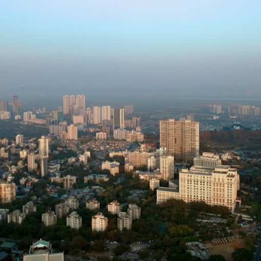 An aerial view of a city with tall buildings, illustrating cloud computing and Indian outsourcers