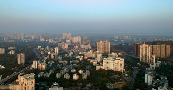 An aerial view of a city with tall buildings, illustrating cloud computing and Indian outsourcers