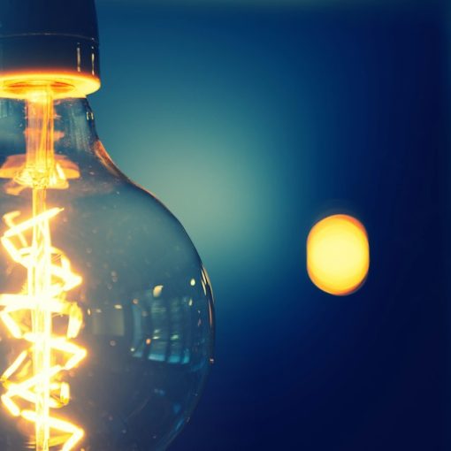 Close up of a glowing light bulb, illustrating cloud solving the IT innovation and maintenance imbalance