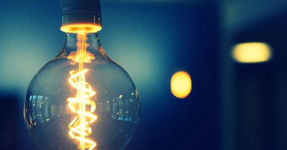 Close up of a glowing light bulb, illustrating cloud solving the IT innovation and maintenance imbalance