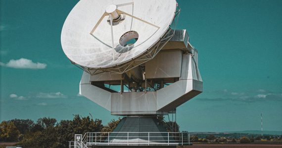 Large satellite dish against a blue sky, illustrating the US intelligence community moving to the cloud