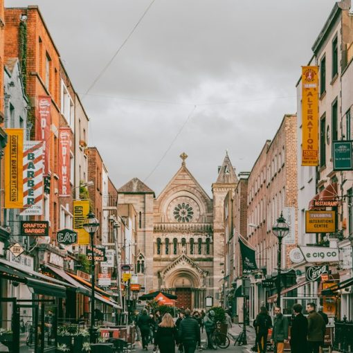 A group of people walking down a street next to tall buildings, illustrating Ireland's cloud computing opportunity