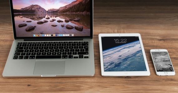 Laptop, tablet and smartphone side by side on a desk, illustrating IT trends shaping 2014 decisions