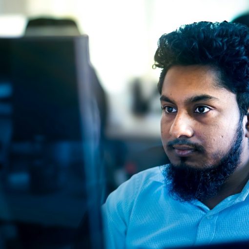 Man working on a computer in an office setting, illustrating IT jobs in the age of cloud