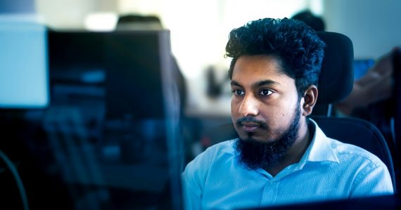Man working on a computer in an office setting, illustrating IT jobs in the age of cloud