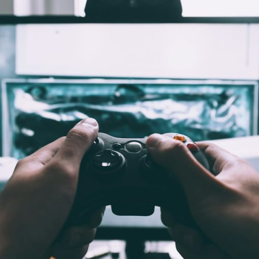 Person holding game controller in-front of television, illustrating Kinect and the future of cloud computing