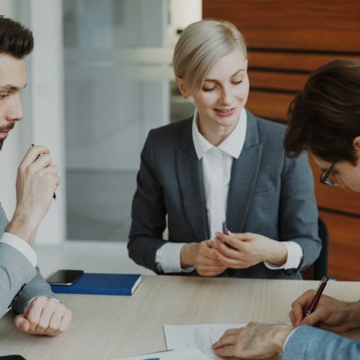 Business people signing a contract at a table, illustrating cloud computing for law firms