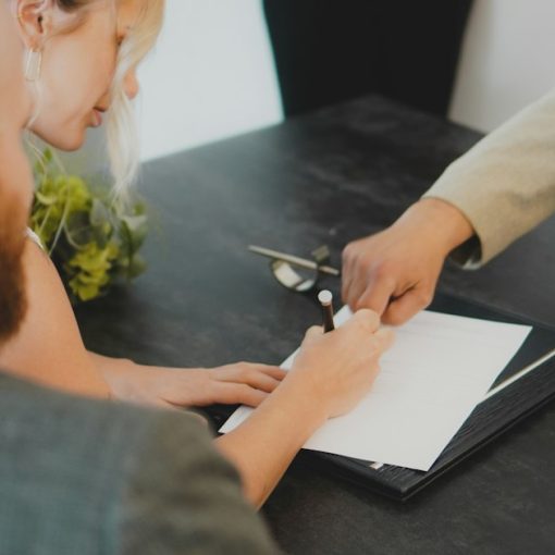 Couple signing document at desk, illustrating desktop virtualization licensing