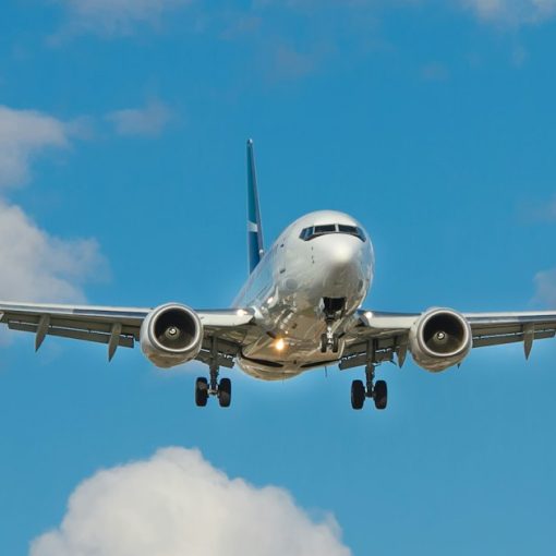 White airplane on mid air, illustrating cloud computing compared to air travel
