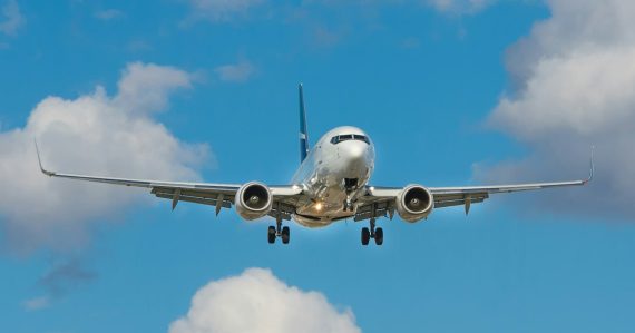 White airplane on mid air, illustrating cloud computing compared to air travel