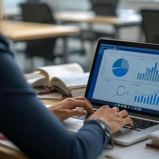 Woman working on laptop with charts and graphs, illustrating improving performance while lowering costs