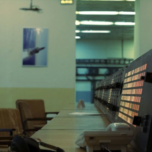 Control room with monitors and chairs, illustrating the cloud and mainframe computing