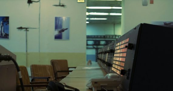 Control room with monitors and chairs, illustrating the cloud and mainframe computing