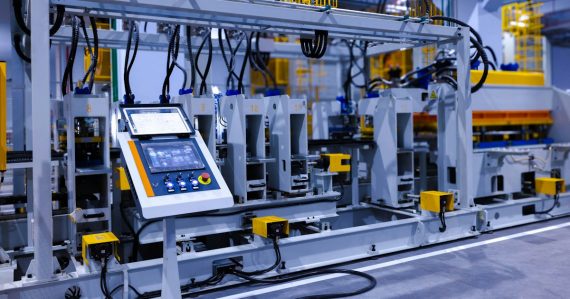 A control panel with a touchscreen on an industrial manufacturing machine, illustrating manufacturing in the cloud