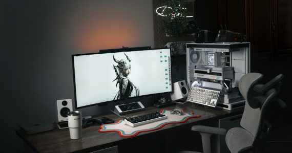Modern computer setup with large monitor and gaming chair, illustrating meshDESK hosted desktop