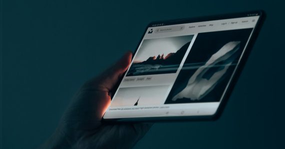 A hand holding a tablet, illustrating mobile cloud computing trends