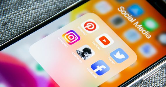 Social media app icons on a smartphone screen with a textured grey background, illustrating a mobile, social, cloud world