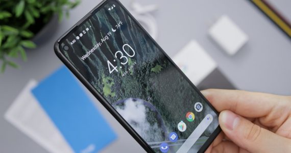Person holding black android smartphone, illustrating virtualized Android phones