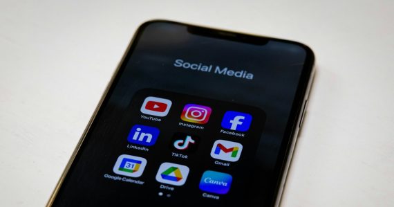 Social media apps displayed on a smartphone, illustrating mobile VoIP growth through social networking