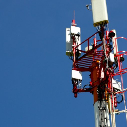 A cell phone tower with a blue sky in the background, illustrating mobility driving cloud adoption
