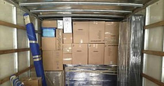 A truck with a bunch of boxes in the back of it, illustrating who will move you to the cloud