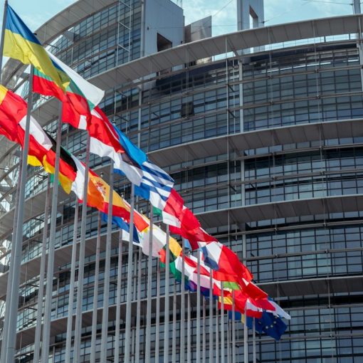 A large building with a lot of flags in front of it, illustrating IBM's cloud system for NATO