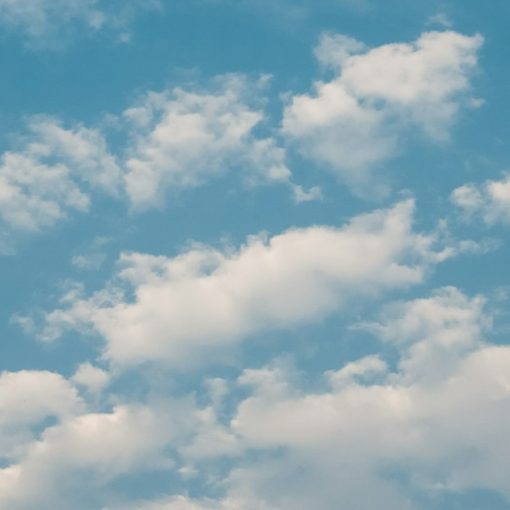 A plane flying in the sky with a lot of clouds, illustrating navigating cloud options for SMBs