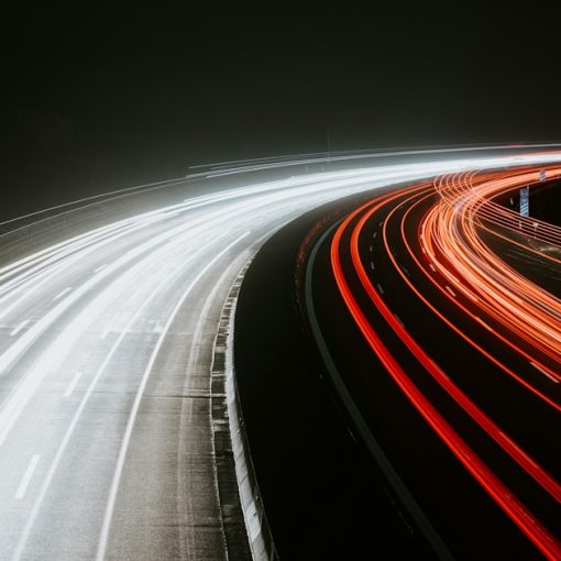 Long-exposure light trails from traffic at night, illustrating the need for speed in the cloud