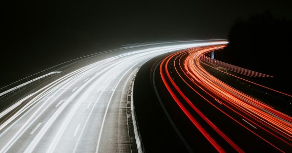 Long-exposure light trails from traffic at night, illustrating the need for speed in the cloud
