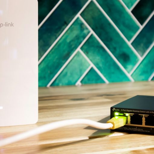A wi-fi router and a network switch sit side-by-side, illustrating networks for desktop virtualization