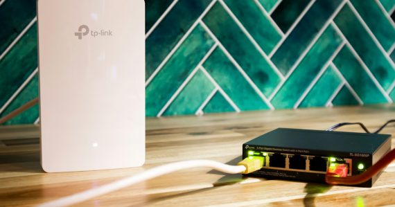 A wi-fi router and a network switch sit side-by-side, illustrating networks for desktop virtualization