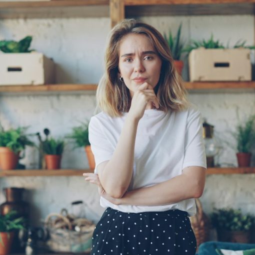 Young woman with hand on chin looking thoughtful, illustrating small business awareness of cloud computing