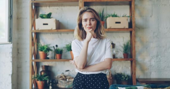 Young woman with hand on chin looking thoughtful, illustrating small business awareness of cloud computing