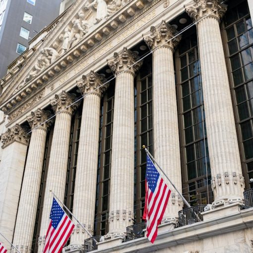 New york stock exchange building with american flags, illustrating NYSE's custom cloud for financial markets