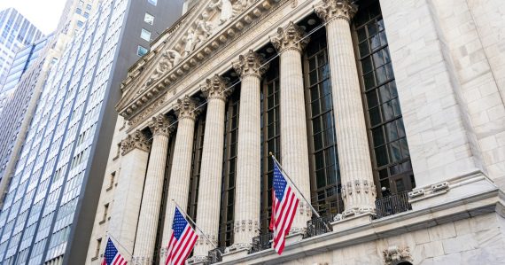 New york stock exchange building with american flags, illustrating NYSE's custom cloud for financial markets