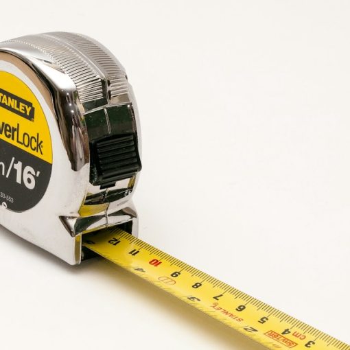 A close up of a tape measure on a white background, illustrating one-size-fits-all cloud computing