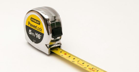 A close up of a tape measure on a white background, illustrating one-size-fits-all cloud computing