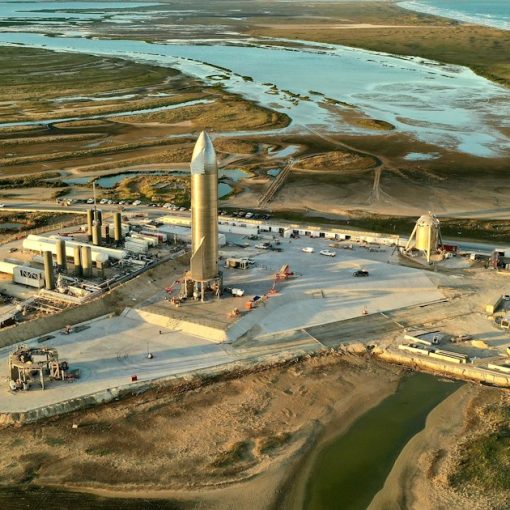 Rocket launchpad with a tall rocket and surrounding structures, illustrating preparing a pathway into the cloud