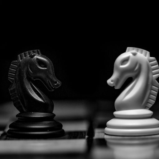 A black and a white chess knight facing each other, illustrating PaaS as the next cloud battleground