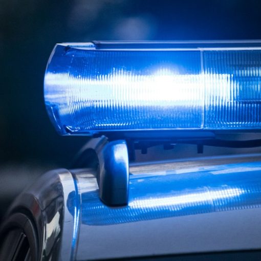 A close up of a police car with its lights, illustrating UK police moving to cloud computing