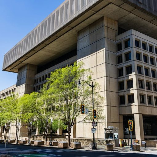 Brutalist building with trees on a sunny day, illustrating federal agencies choosing private clouds