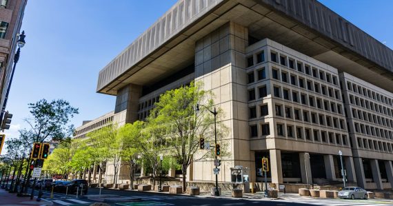 Brutalist building with trees on a sunny day, illustrating federal agencies choosing private clouds