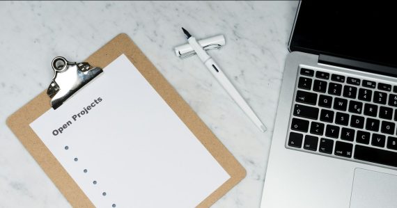 White printer paper beside silver laptop computer, illustrating private cloud investment priorities