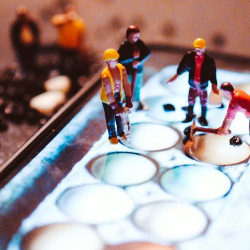 Tiny model construction workers working on a mobile phone screen, illustrating IT managers predicting cloud adoption
